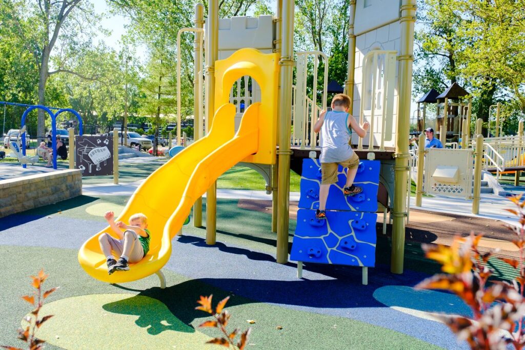 children playing on yellow sliding ride